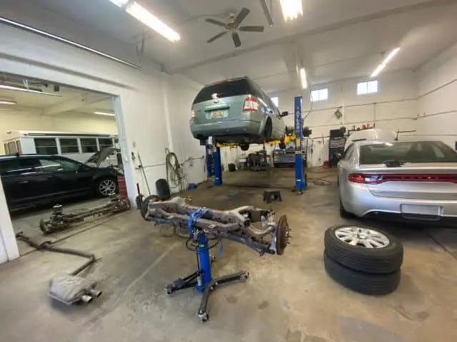 A team of skilled technicians at Nogueira Automotive Mechanic, LLC using state-of-the-art equipment to perform precise alignment services on a vehicle.