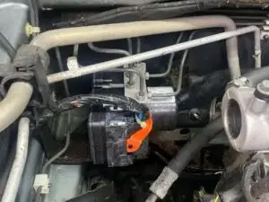 A technician at Nogueira Automotive Mechanic, LLC performing repairs and maintenance on a vehicle's anti-lock brake system to ensure optimal performance and safety.