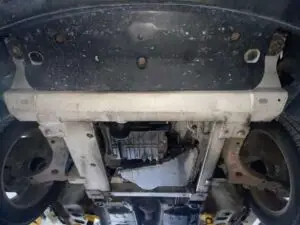 A technician at Nogueira Automotive Mechanic, LLC performing maintenance and repairs on a Buick vehicle, ensuring optimal performance and safety.