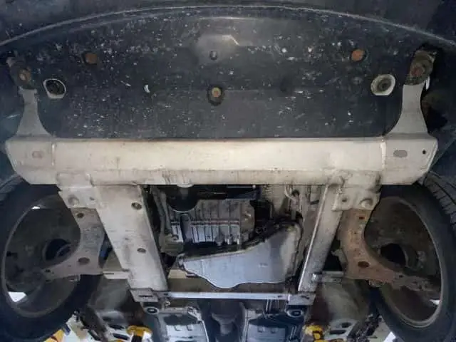 A technician at Nogueira Automotive Mechanic, LLC performing maintenance and repairs on a Buick vehicle, ensuring optimal performance and safety.