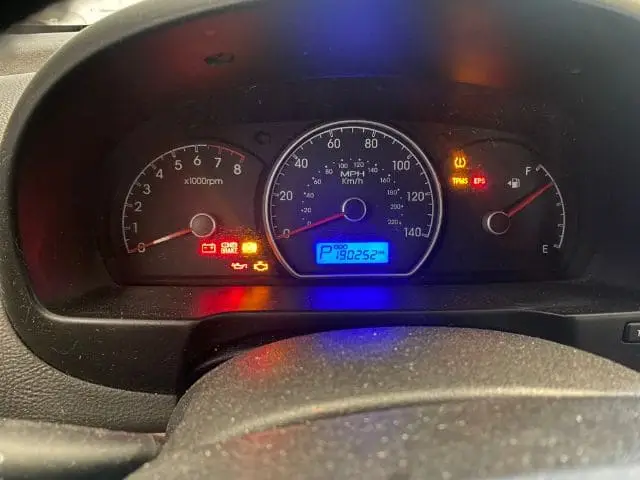 A technician at Nogueira Automotive Mechanic, LLC using diagnostic equipment to troubleshoot and repair a vehicle's Check Engine Light issue.