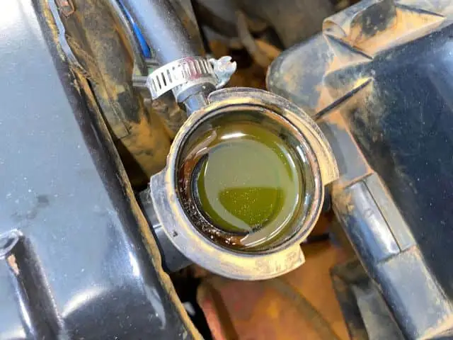 Car being serviced with a coolant system flush