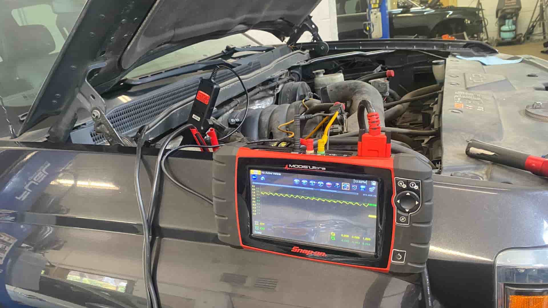 A team of skilled technicians at Nogueira Automotive Mechanic, LLC using advanced diagnostic equipment to accurately diagnose and troubleshoot a vehicle's issues.