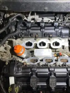 A technician at Nogueira Automotive Mechanic, LLC performing general repair and maintenance services on a domestic vehicle to ensure optimal performance and safety.