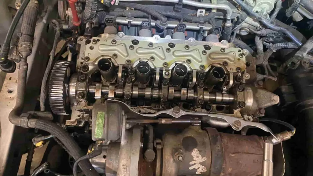 A technician at Nogueira Automotive Mechanic, LLC performing repairs and maintenance on a vehicle's engine and transmission to ensure optimal performance and longevity.