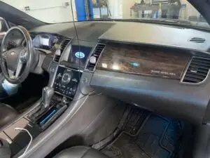 A technician at Nogueira Automotive Mechanic, LLC pointing out common signs of A/C system problems, such as warm air coming from the vents, strange noises, or leaks, that may indicate that your vehicle's air conditioning system may be having issues.