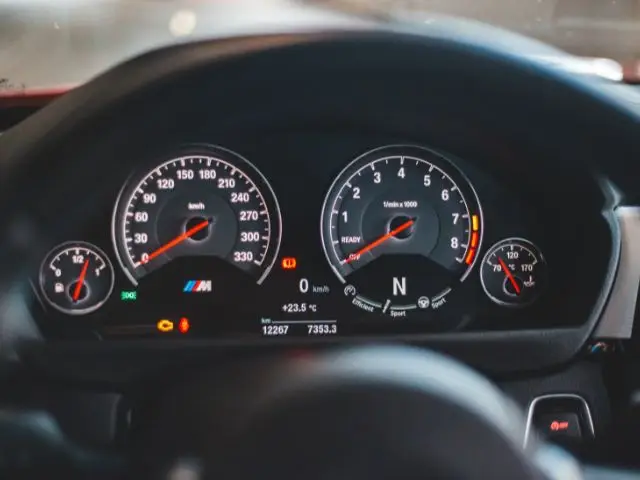 A dashboard with the check engine light illuminated