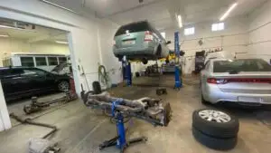 A team of skilled technicians at Nogueira Automotive Mechanic, LLC performing a wide range of repair and maintenance services on a vehicle to ensure optimal performance and safety.