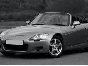 A mechanic performing a repair on a Honda car