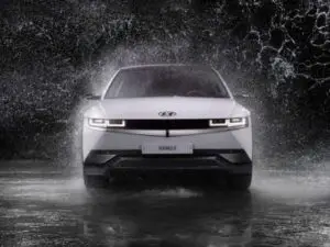 A mechanic performing a repair on a Hyundai car