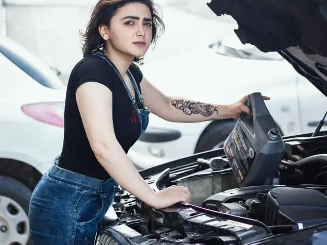 Car with the hood open during an oil change service