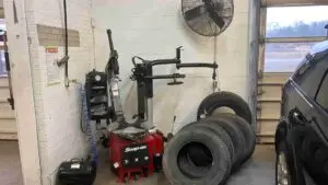 A technician at Nogueira Automotive Mechanic, LLC carefully inspecting and replacing a vehicle's tires to ensure optimal performance and safety.