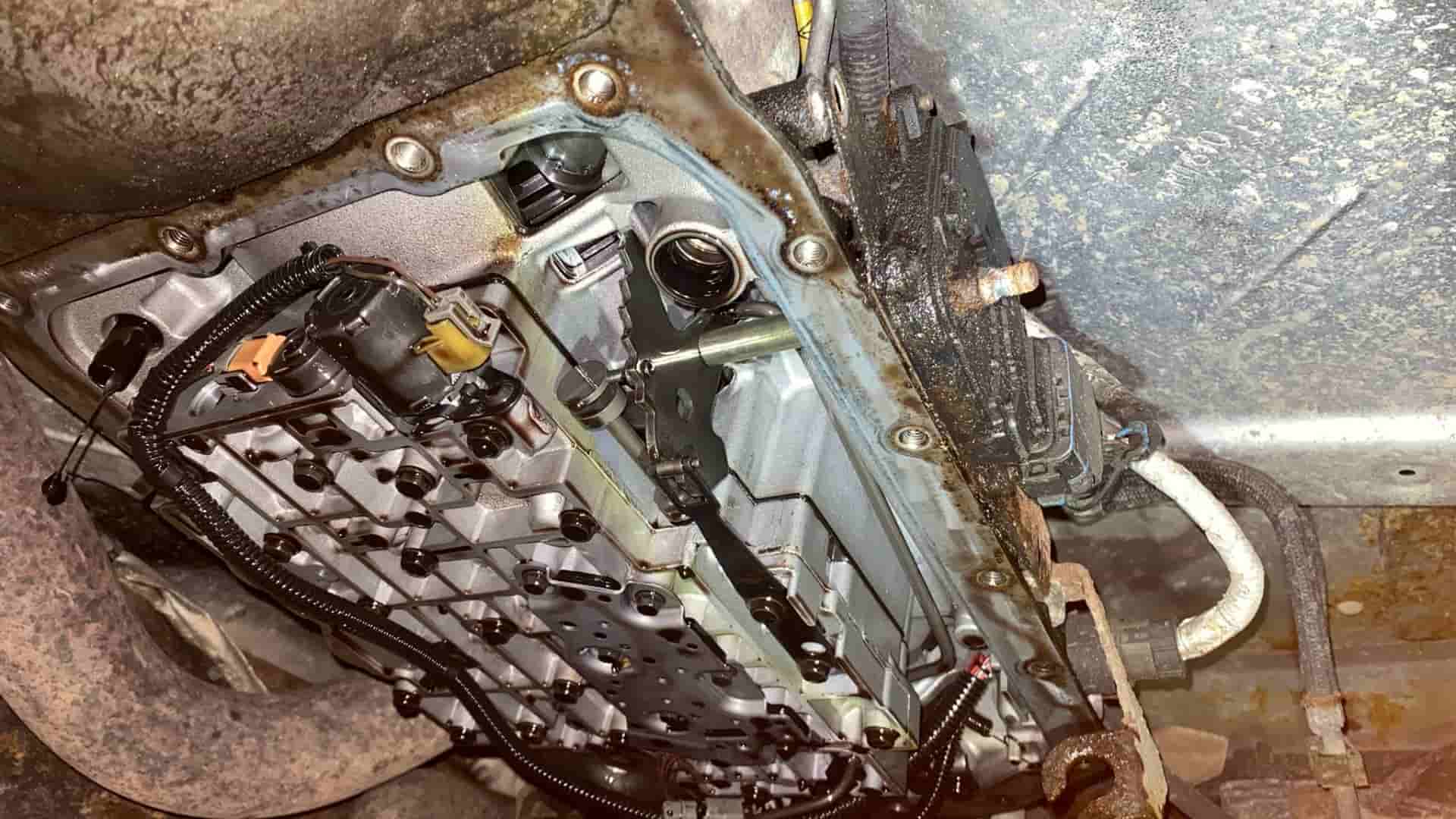 A technician at Nogueira Automotive Mechanic, LLC performing repairs and maintenance on a vehicle's transmission system to ensure optimal performance and longevity.