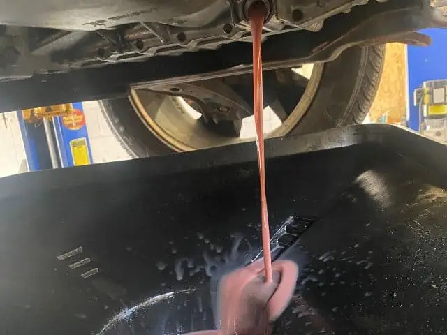 Car transmission being serviced in a mechanic shop