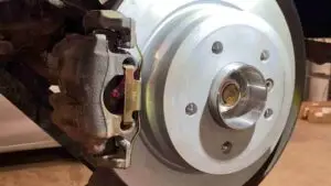 Image of a mechanic performing a brake service on a vehicle, highlighting the importance of regular brake maintenance for the safety and proper functioning of the vehicle.