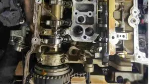 A mechanic performing an engine maintenance check on a car